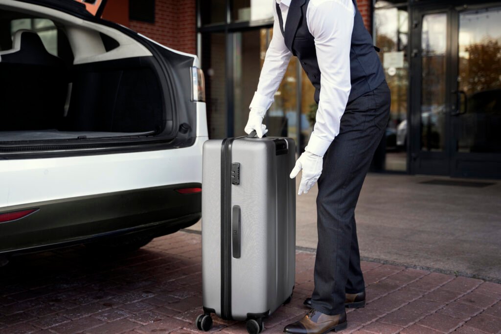 Chauffeur assisting with luggage in luxury taxi for Disneyland transfer